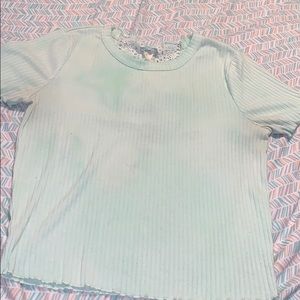 A green crop top with lace.